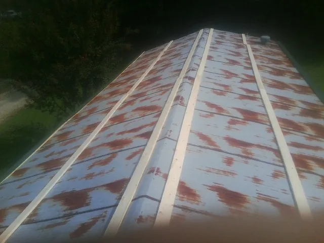 Rusted metal roof panels with new wood purlins before replacement — Storm Damage Roof Repair in Colusa by Roofing Brothers